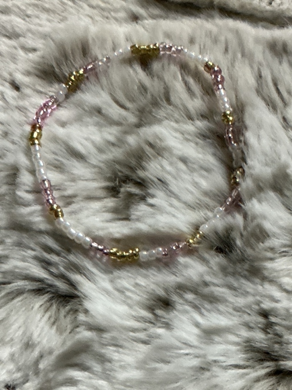 Homemade bracelets the colors are gold pearl and soft pink